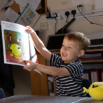 Child reading Monster Phonics meet the monsters books