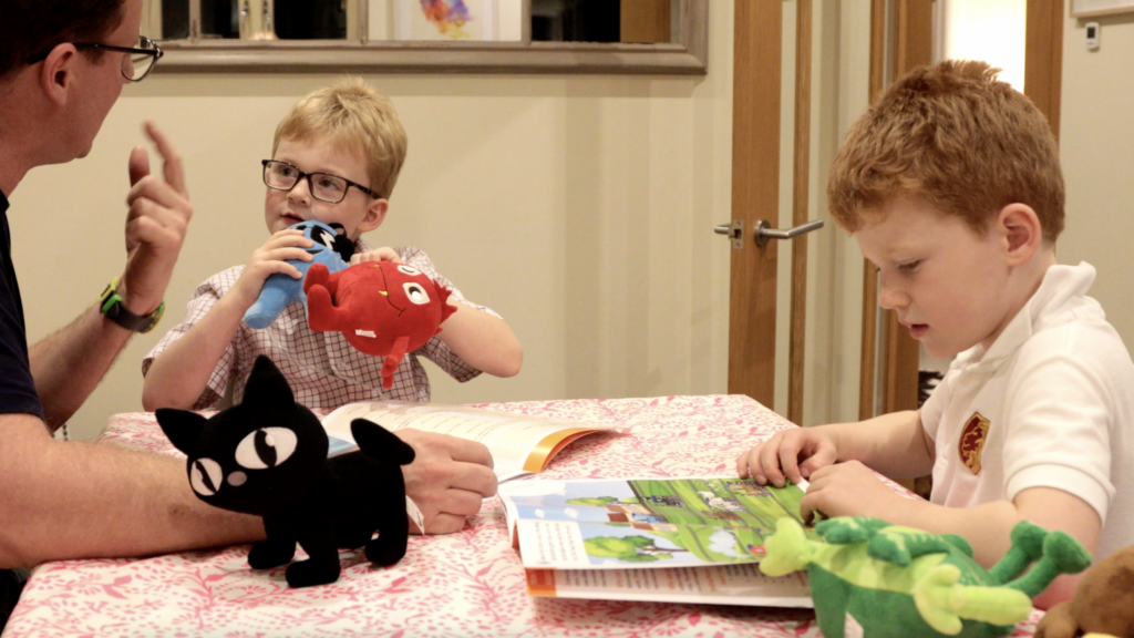 Image of children and their parent learning at home